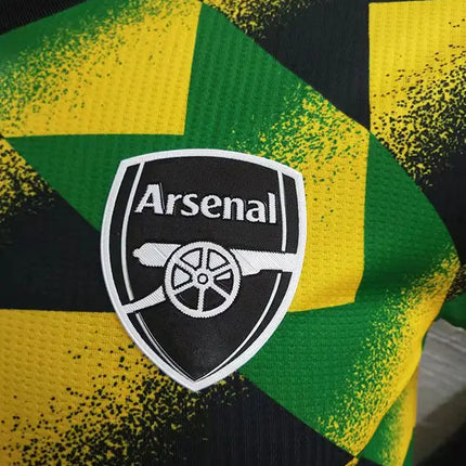 Maglia arsenal pre-match 2022/23 con crest del club di calcio su jersey giallo e verde a motivi geometrici
