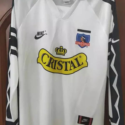 Maglia maniche lunghe colo-colo home retro 1995 96 bianca con motivi geometrici neri e logo cristall giallo nel petto