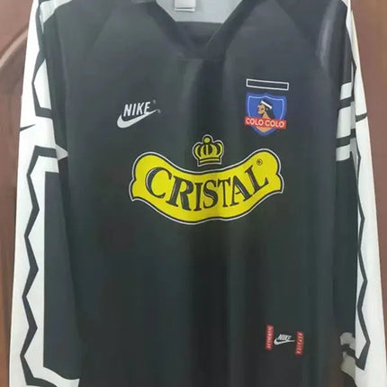 Maglia maniche lunghe retro colo-colo trasferta 1995 96 nero con rifiniture geometriche bianche e logo cristal giallo