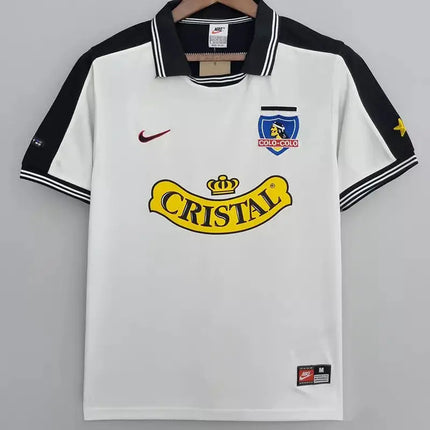 Maglia retro Colo-Colo home 1999 00 bianca con maniche e colletto neri e logo sponsor cristal giallo sul petto