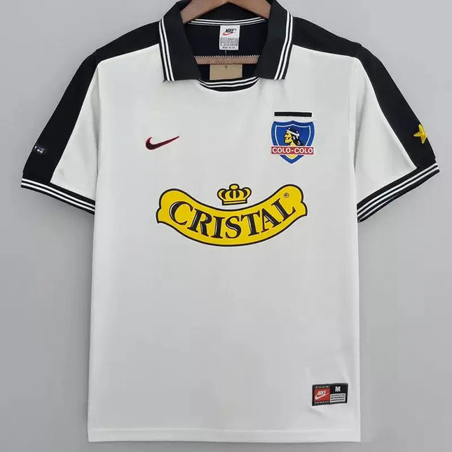Maglia retro Colo-Colo home 1999 00 bianca con maniche e colletto neri e logo sponsor cristal giallo sul petto