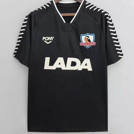 Maglia retro colo-colo trasferta 1991 92 nera con logo lada bianco stemma indigeno e bordi a zigzag sulle maniche