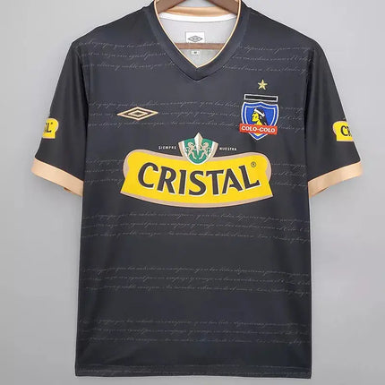 Maglia retro colo-colo trasferta 2011 12 nera in tessuto tecnico con rifiniture oro logo giallo cristal e stemma club