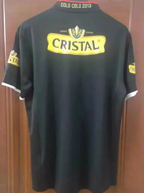 Maglia retro colo-colo trasferta 2013/14 nero con logo cristallino giallo e testo colo colo 2013 sul colletto