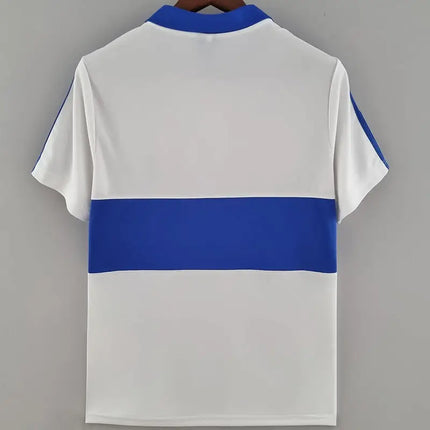 Maglia retro universidad catolica home 1987 88 bianca con fascia orizzontale blu reale e colletto e bordi delle maniche abbinati