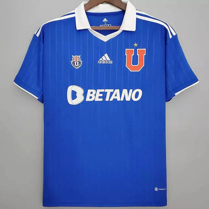 Maglia universidad de chile home 2022/23 in royal blue with white pinstripes collar trim and orange u logo on chest